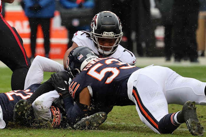 Dec 31, 2023; Chicago, Illinois, USA; Chicago Bears linebacker T.J. Edwards (53) makes a tackle on Atlanta Falcons running back Bijan Robinson (7) during the first half at Soldier Field.